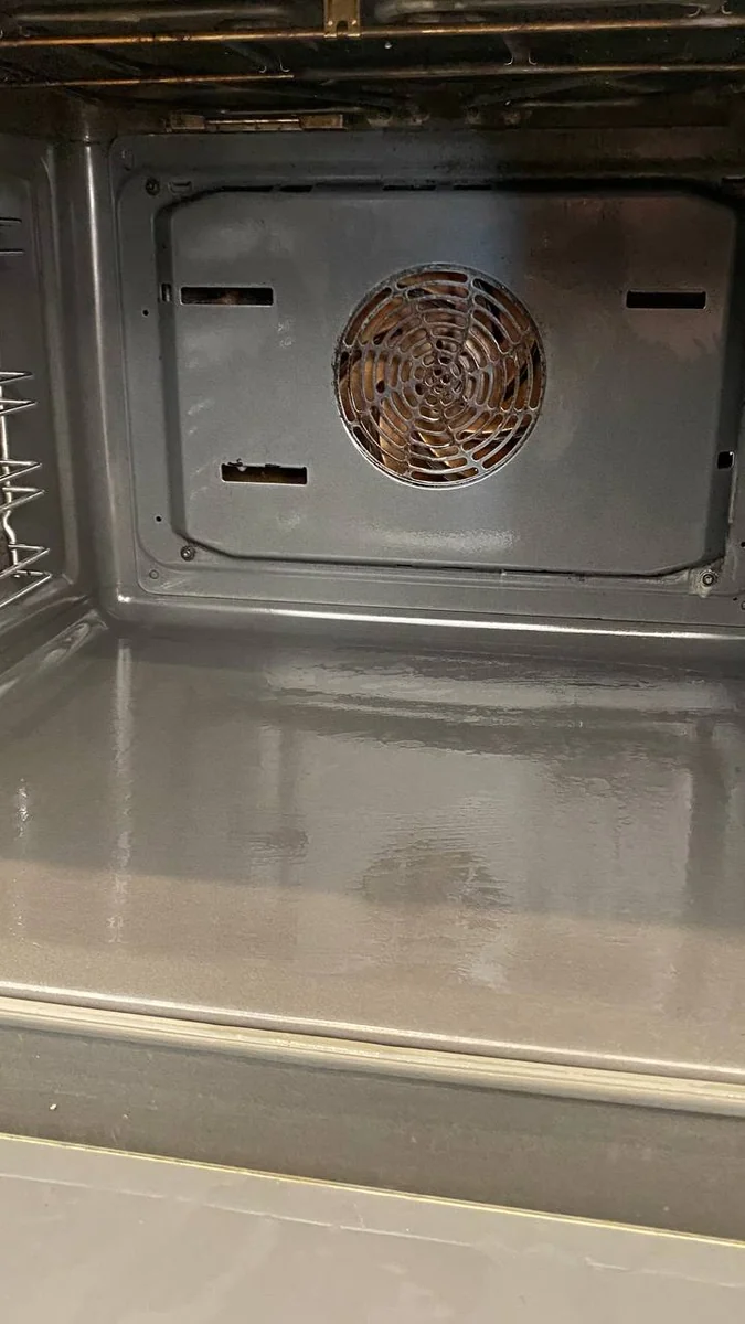 Oven interior and fan cover clean after degreasing during a deep clean