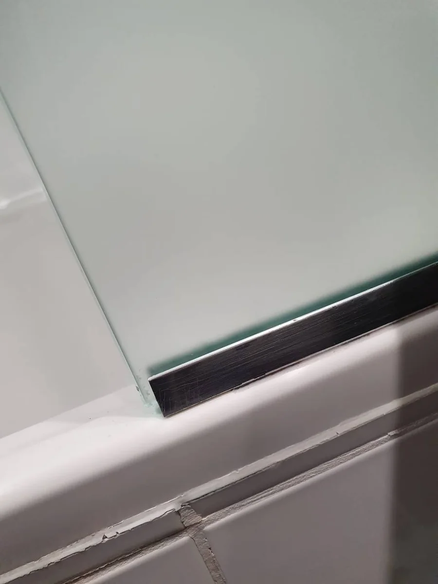 Shower screen and bath edge clean after limescale and mould removal