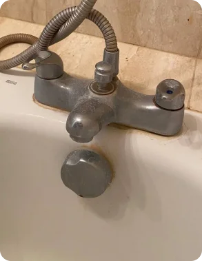 Bath tap covered in limescale before an eco-friendly deep clean